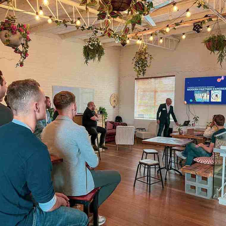 a group of people sitting around a living room