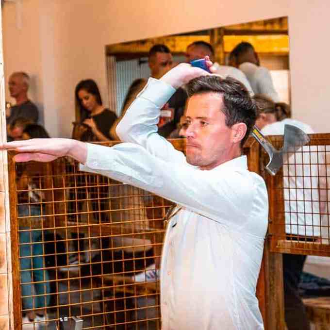 a man standing next to a net