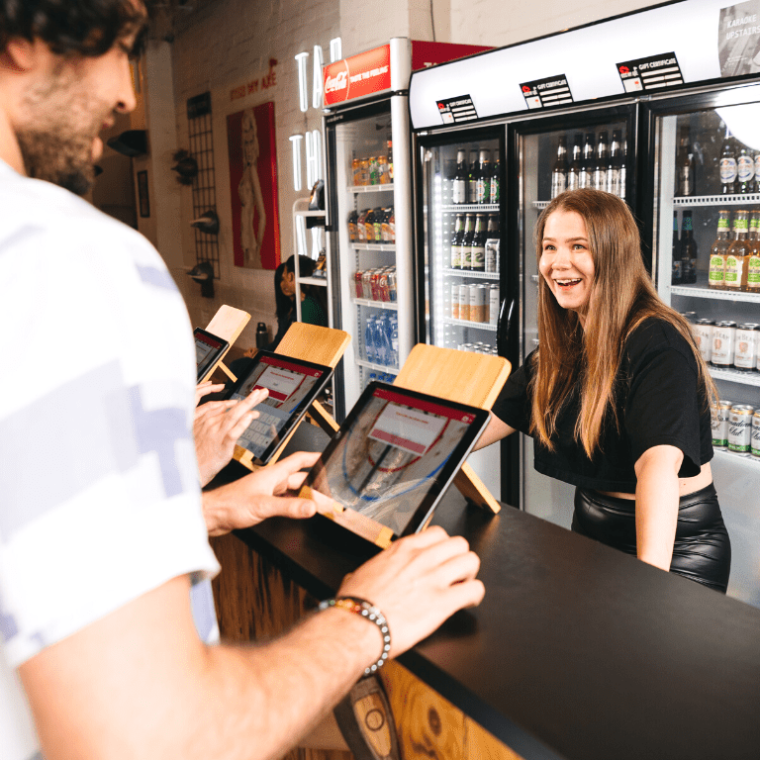 a person sitting at a table looking at a book