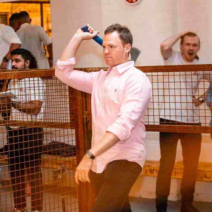 a group of people standing in a cage