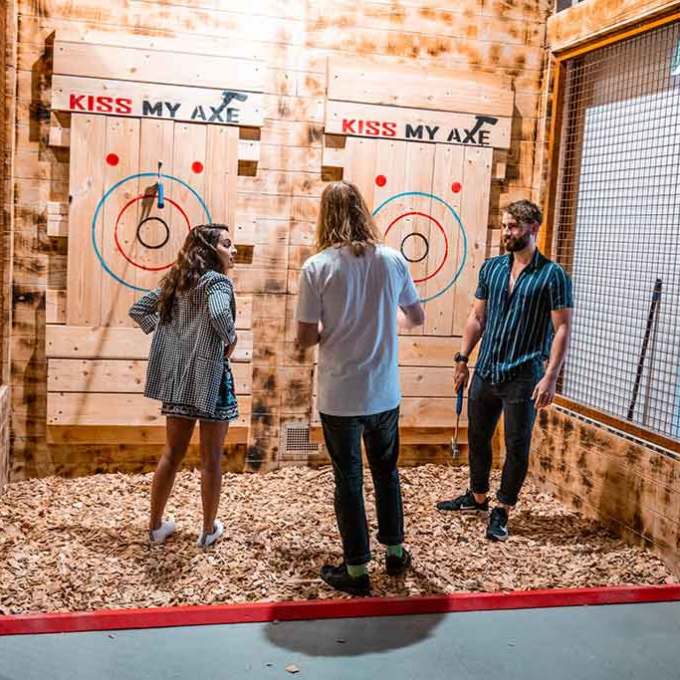 a group of people standing in front of a fence