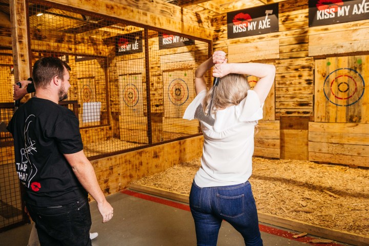 a man standing next to a building