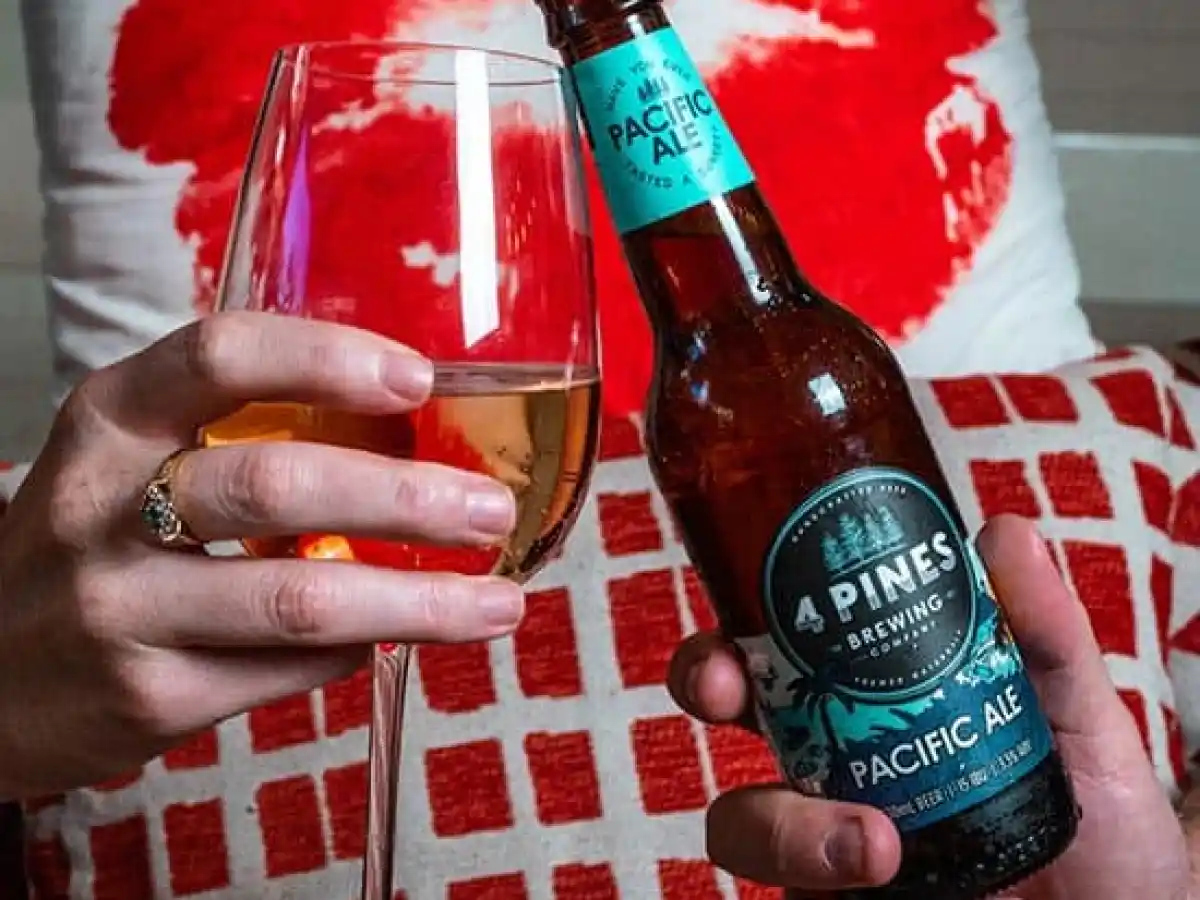 a hand holding a bottle of wine