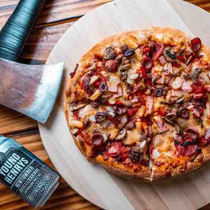 a slice of pizza sitting on top of a wooden cutting board