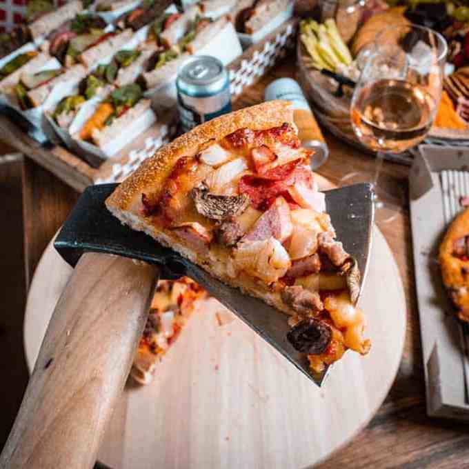 a slice of pizza sitting on top of a wooden table