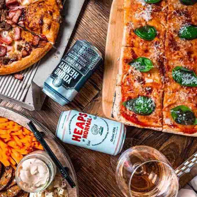 a pizza sitting on top of a wooden table
