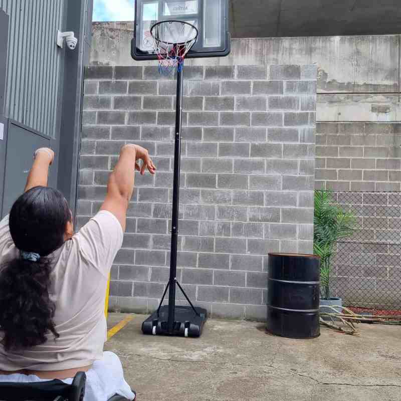 a man riding a motorcycle in front of a building