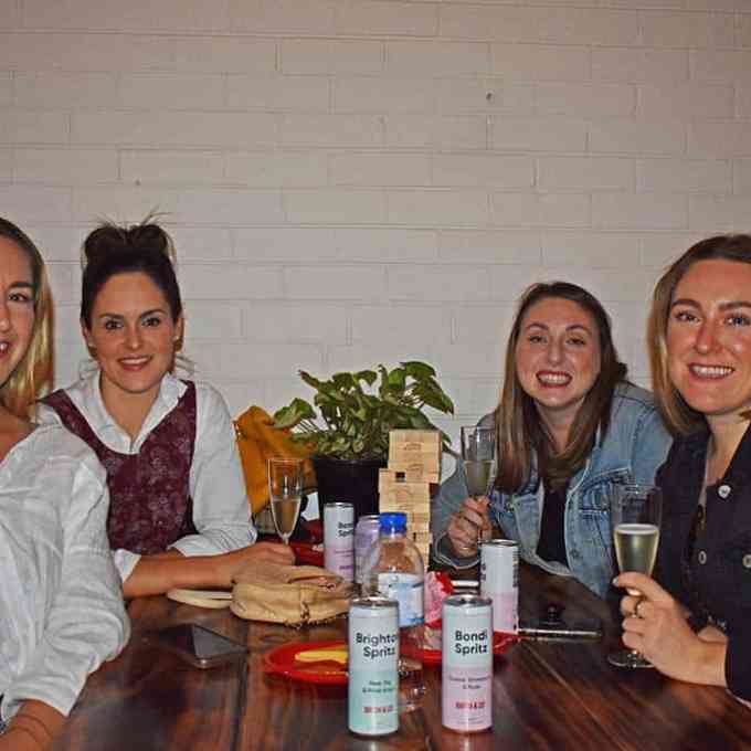 Jordan Jankun et al. sitting at a table with wine glasses