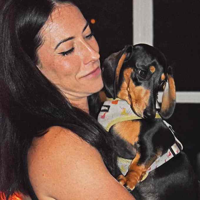 a woman holding a dog