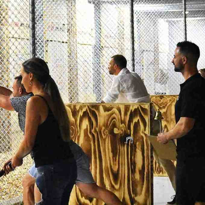 a group of people standing next to a fence