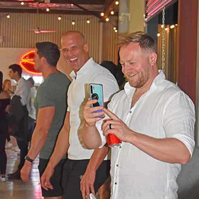 a group of people holding wine glasses