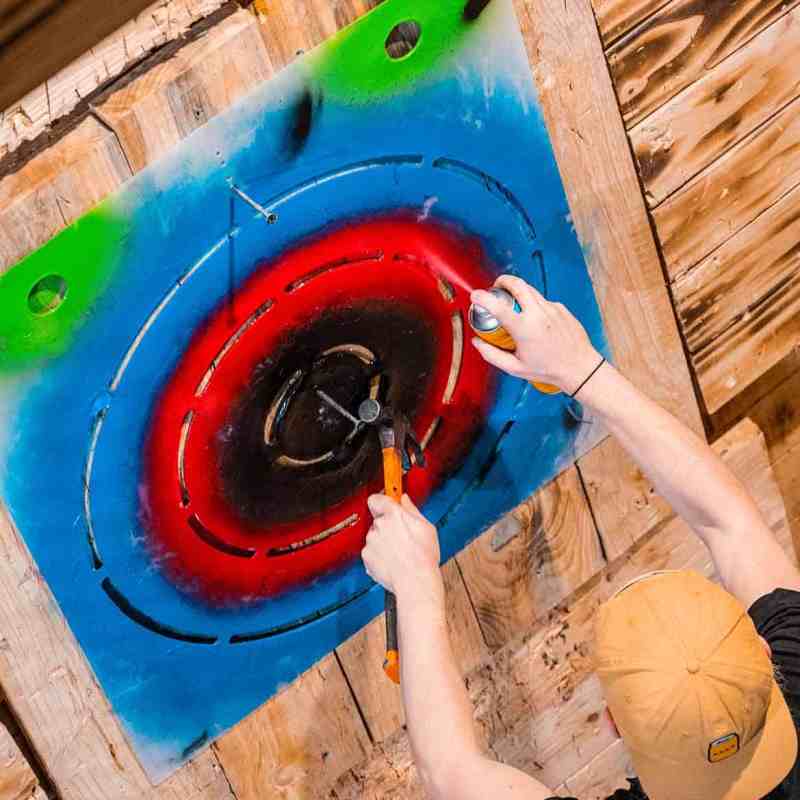 staff spray paint wood to create axe throwing target practice