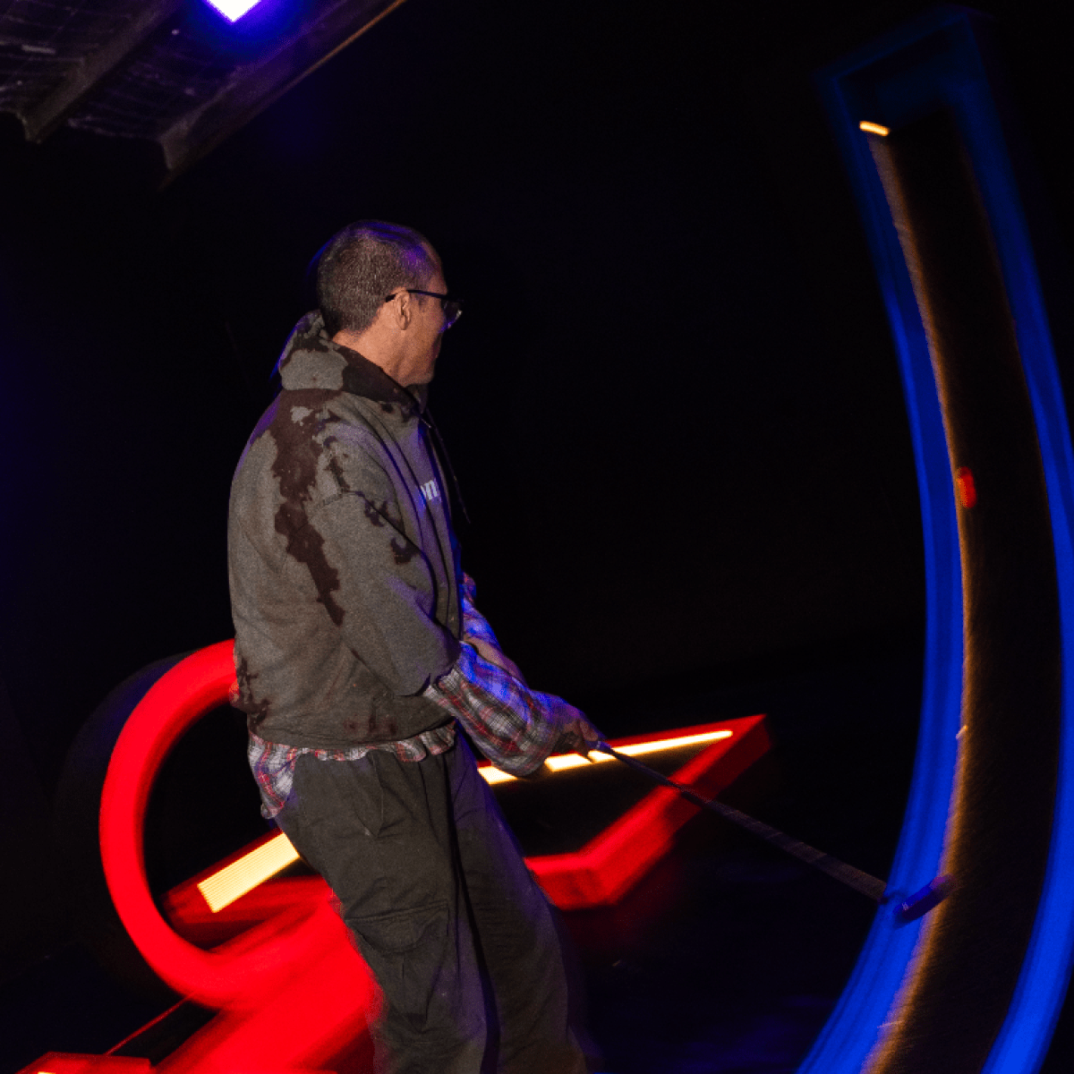 man mid jump after mini golf swing