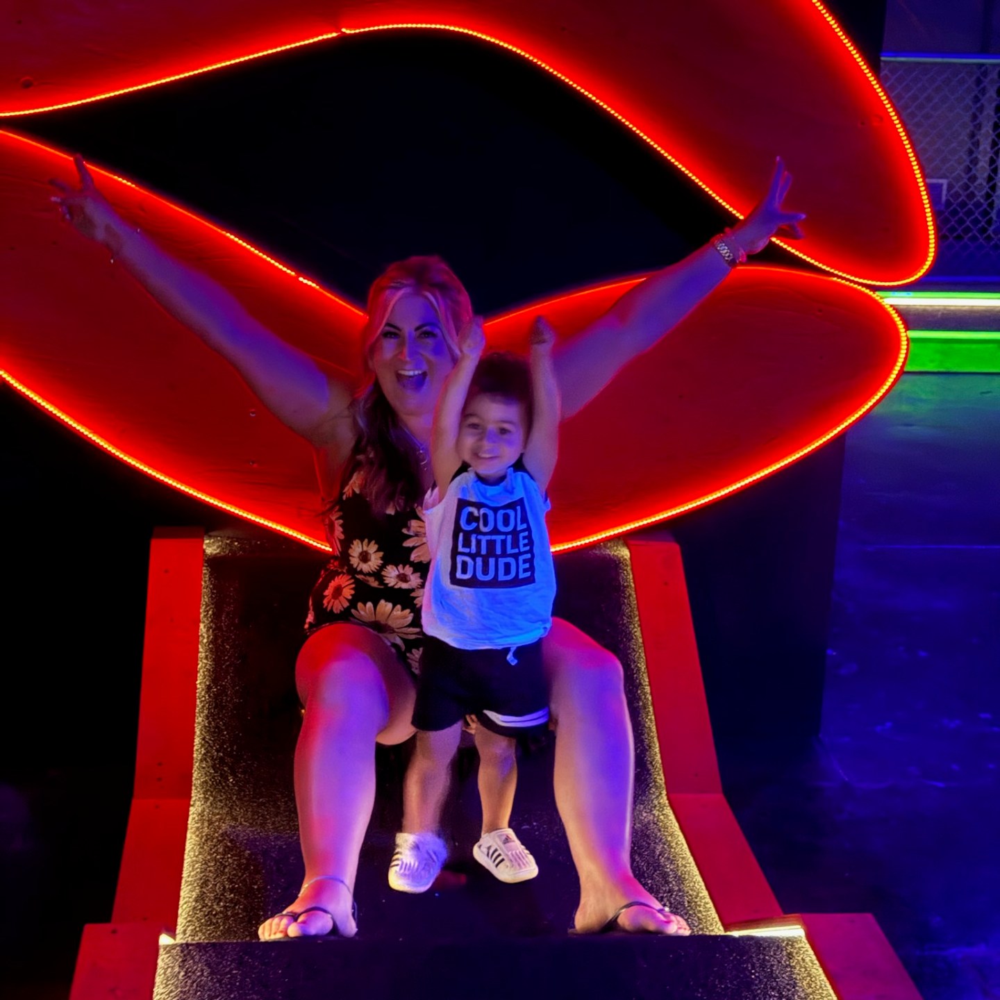 Mother and son pose on mini golf course