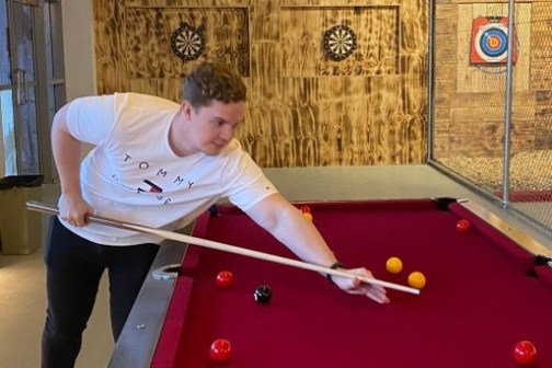 boy playing a pool table game