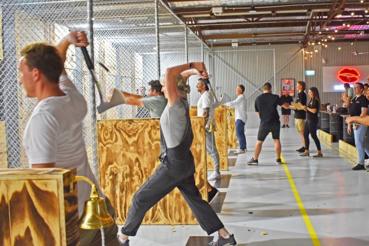 a group of people standing next to a fence