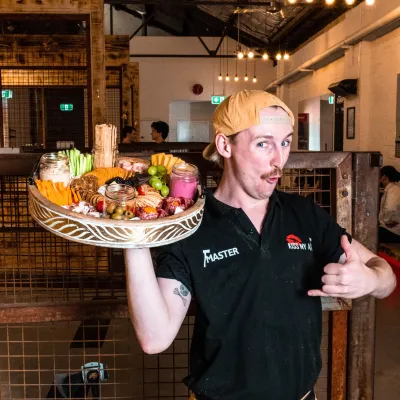 person holding a plater of food for a kiss my axe sydney party