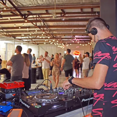 Man playing DJ music for a Kiss My Axe throwing event in Sydney